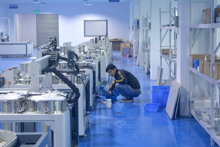 Technician assembling Robota resin doming equipment