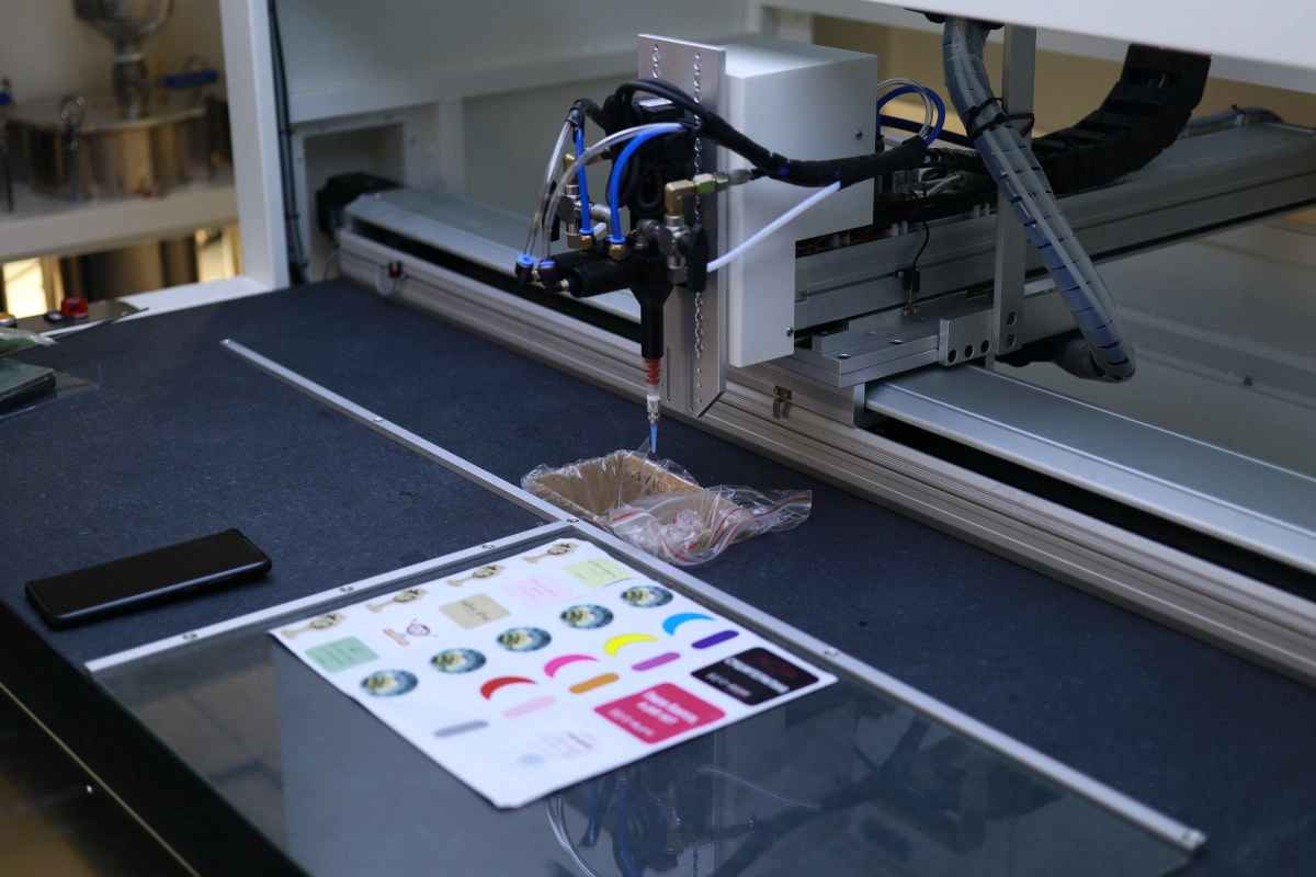 How to Prepare Printed Labels Before Resin Doming Mixed-design sticker sheet placed on an SJ4060 vision doming machine worktable