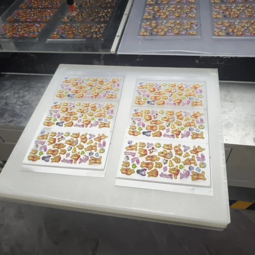 Temperature, Humidity, and Cure Time in Resin Doming Freshly dispensed domed sticker sheets staged on level trays before curing