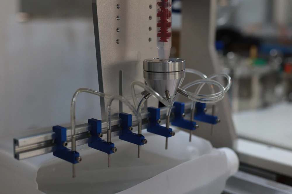 Adjustable multi-nozzle resin dispensing assembly
